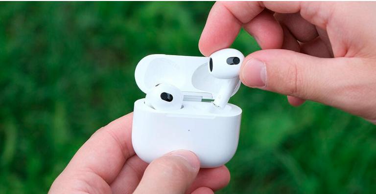 A person Inserting AirPods in its case
