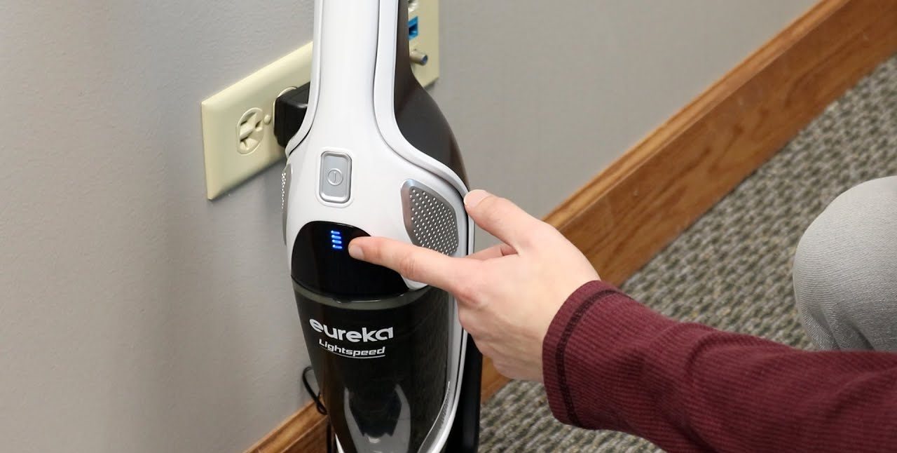 A Eureka vacuum plugged into a power outlet