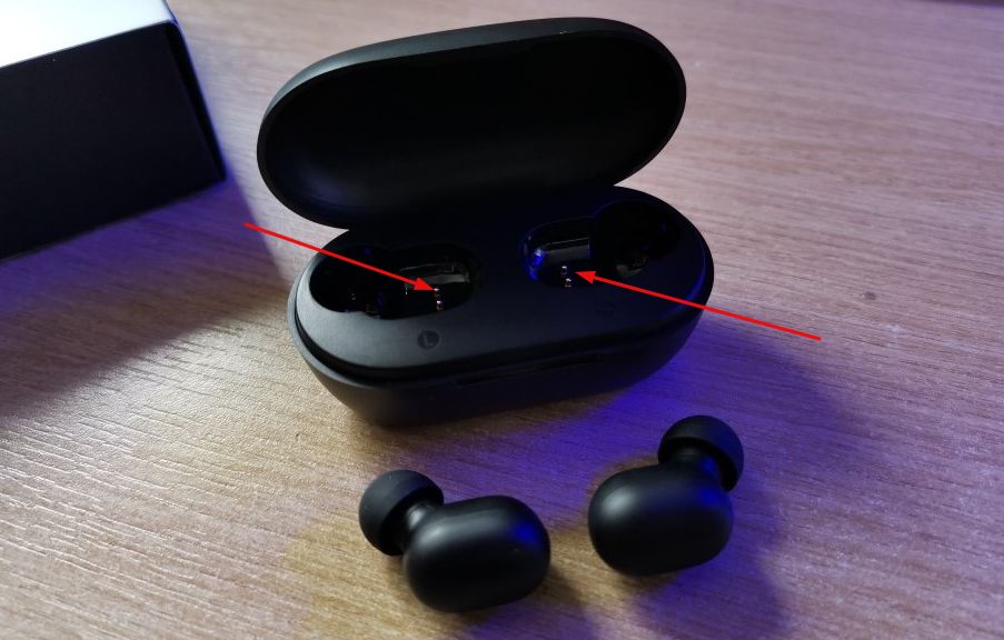 Haylou GT1 Pro earbuds case with two arrows pointing towards charging pins