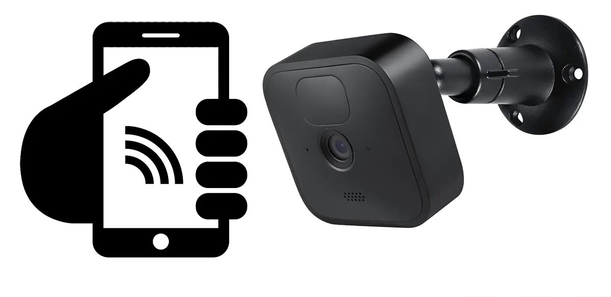 A Blink camera along with a black hand holding a cell phone with a wi-fi icon on the screen