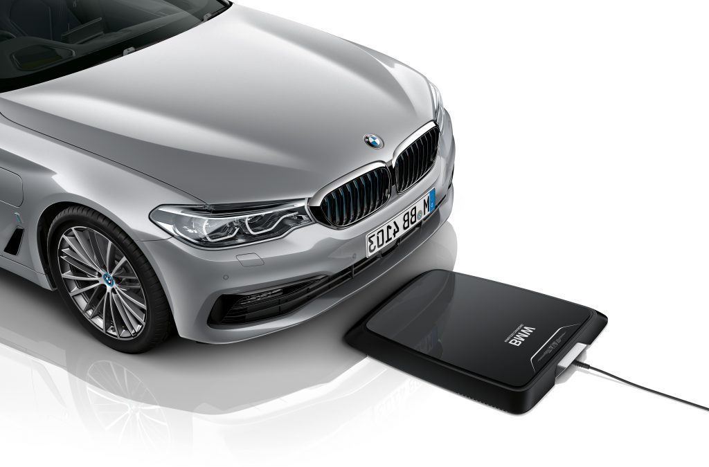 A BMW standing infront of wireless charing pad