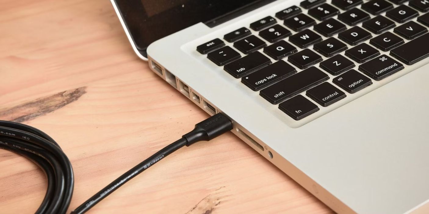 A cable plugged into a USB Port of a computer