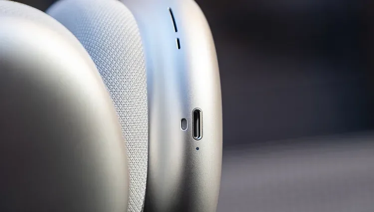 Close-up of AirPods Max with focus on the ear cups, revealing the charging port